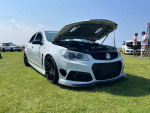 2015 Chevrolet SS with custom modifications displayed on grass at a car show