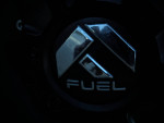 Close-up of a Ford vehicle's fuel cap with a modern design, emphasizing durability and style in trucks.