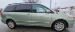 2008 Toyota Sienna XLE 7-passenger van, silver color, parked with snow in the background