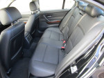 Interior view of a 2011 BMW 328i XDrive featuring black leather seats and good condition.