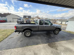 2010 Ford Ranger XLT Extended Cab in army green parked, showing its exterior features and condition.