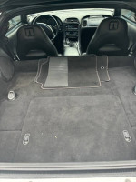 Interior view of a 2003 Chevrolet Corvette with clean black carpet and floor mats.