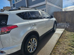 2018 Toyota RAV4 Limited FWD parked in driveway, showcasing exterior details and wheels.