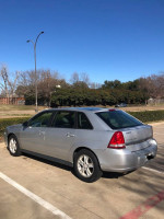 2004 Chevrolet Malibu Maxx in silver parked outdoors, showcasing its clean body and strong design.