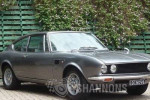 1972 Ferrari Fiat Dino parked outdoors, showcasing its sleek design and vintage appeal.