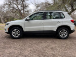 Side view of a 2016 Volkswagen Tiguan SE 4Motion AWD parked in a natural setting.