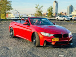 2015 BMW M4 Convertible in red with 700+ horsepower, showcasing its clean design and stylish exterior.