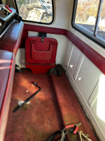 Interior view of a 1978 Ford F250 showing red upholstery and tools, highlighting the restoration process.