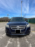 Front view of a 2011 Volkswagen Tiguan SEL in dark blue with panoramic sunroof and stylish design.