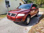 2005 Volkswagen Touareg V6 SUV in red, showcasing clean exterior and surroundings, low mileage of 78,000 miles.