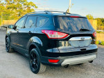 2016 Ford Escape Titanium FWD in black with alloy wheels, showcasing its clean design and features.