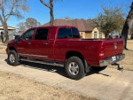 2006 Dodge Ram 2500 4X4 mega cab in red, fully loaded with leather seats and towing hitch.
