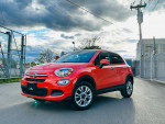 2016 Fiat 500X Easy Edition in orange, featuring alloy wheels and a clean exterior, parked outdoors.