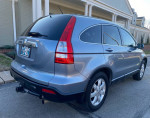 2008 Honda CR-V EXL 4WD in blue, showcasing quality and excellent condition, parked in front of a house.