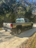2001 Chevrolet Silverado 2500 4x4 parked on a dirt road, showcasing its durable exterior and clean condition.