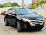 Black 2013 Ford Edge SEL FWD parked on the street, showing stylish design and chrome accents.