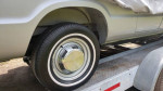 Close-up of a Dodge B300 wheel on a trailer, showcasing its classic style and electric vehicle features.