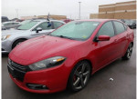 2014 Dodge Dart GT in red, featuring a sleek design and alloy wheels, parked among other vehicles.