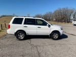 2005 Honda Pilot 4WD parked outdoors, showcasing clean exterior and new tires amidst a clear sky.