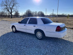 2008 Grand Marquis LS for sale with 119,000 miles, shown in white against a clear sky.