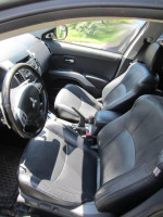 Interior view of 2011 Mitsubishi Outlander XLS with leather seats and modern dashboard features