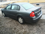 2005 Chevrolet Malibu LS in gray, parked on gravel, showcasing its clean exterior and new paint details.