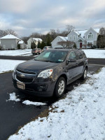 2014 Chevrolet Equinox LT AWD parked on snow-covered driveway surrounded by houses