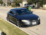 2007 Audi A4 2.0T FWD parked on the street, showcasing its sleek black design and modified features.