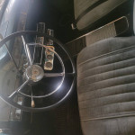 Interior view of a 1958 Ford Edsel Ranchero with vintage steering wheel and dashboard details.