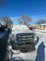 2014 Ford F250 Super Duty in snow, showcasing mileage and condition for sale by retired construction worker.