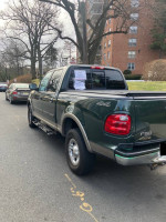 2002 Ford F150 Super Crew Cab for sale, green truck with clean title and 132,336 miles, ideal for work or daily use.