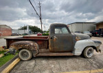 1950 GMC 100 Half Ton Step Side truck, in need of restoration, parked on a street.
