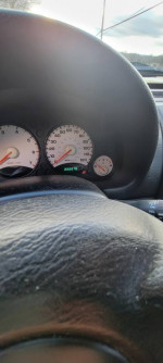 Dashboard view of a 2003 Jeep Liberty Sport showing mileage and gauges, for sale as parts or repair.