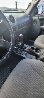 Interior view of a 2003 Jeep Liberty Sport 4WD with manual transmission and features like AC and sunroof.