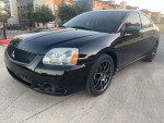 2011 Mitsubishi Galant in black with upgraded features and 131,000 miles, parked outdoors
