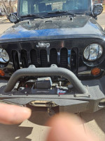Front view of a 2012 Jeep Rubicon with Smittybilt winch and custom bumpers