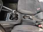 Interior view of a well-maintained 2007 VW Jetta five-speed with black cloth seats and gear shift.