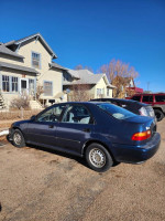 1995 Honda Civic DX in good condition parked outside, featuring original parts and 122,000 miles.