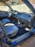 Interior view of 1995 Honda Civic DX with gray seats and dashboard, showcasing original condition and clean title.