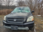 2003 Honda Pilot 4x4 with leather and DVD, 87,000 miles, black color, parked in a rustic outdoor setting.