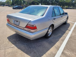 1999 Mercedes S420 car parked in a lot, showcasing its sleek silver exterior and well-maintained features.