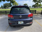 2015 Volkswagen Tiguan SE 4Motion AWD parked in a lot, showcasing rear view and roof rack.