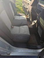 Interior view of a 2010 Chevrolet Malibu with low mileage, featuring clean back seats and spacious layout.
