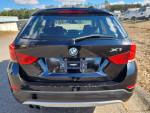 Rear view of a 2015 BMW X1 AWD in excellent condition, showcasing its sleek design and black color.
