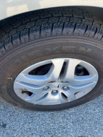 Close-up of the wheel and tire of a 2006 Honda Odyssey with new tires for sale.