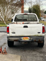 Rear view of a white 2004 Ford F350 diesel truck with visible rust and a Maryland license plate.