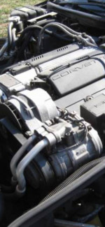 Close-up of the engine of a 1994 Chevrolet Corvette, showcasing its well-maintained components and original parts.
