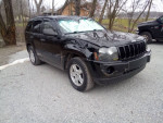 2006 Jeep Cherokee Laredo with clean title, all wheel drive, and minor cosmetic damage parked outdoors.