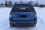 Rear view of a 2010 Subaru Forester 2.5X AWD in snowy conditions, showcasing its clean design and winter readiness.