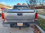 Rear view of a 2008 GMC Sierra SLE truck with towing package, showing typical dash cracks and well-maintained tires.
